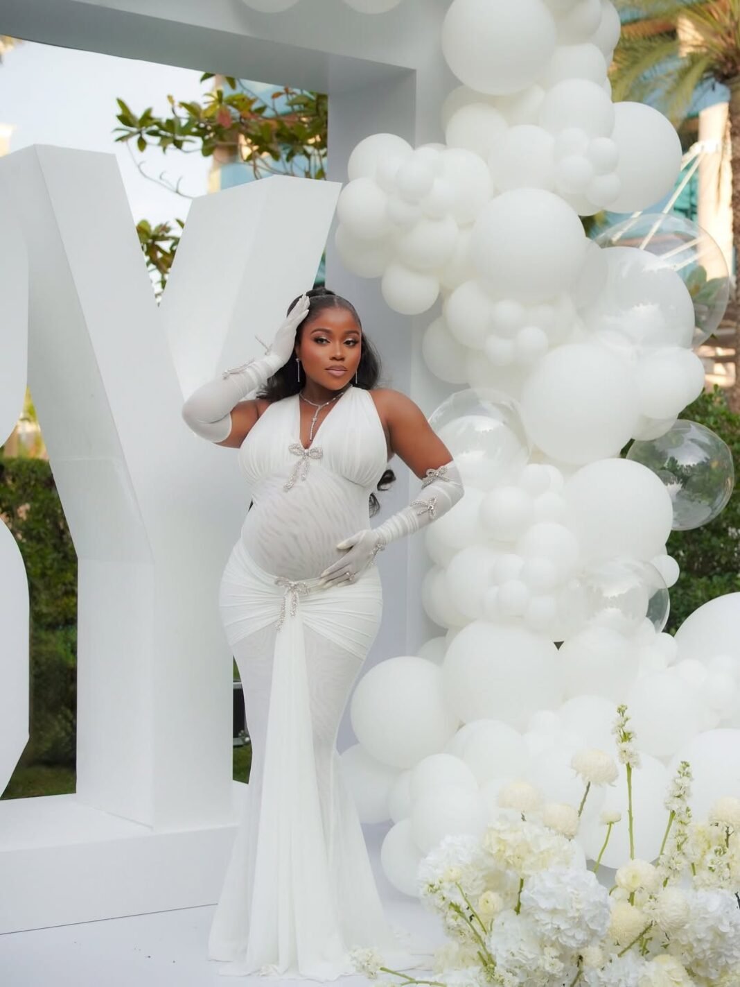 Veekee James’s White Maternity Gown Featured Opera Gloves and Crystal Details