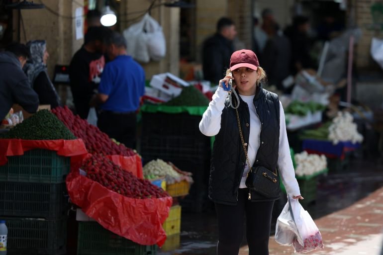 Amid US-Israeli attacks, people in Iran struggle to survive ailing economy