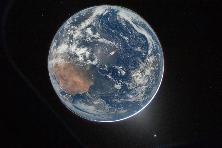 Earth in rear-view of Artemis II astronauts